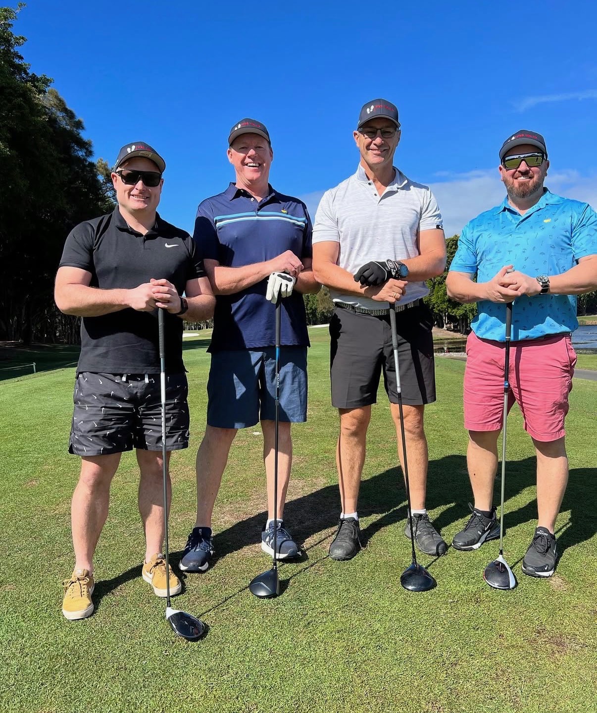 Four players with drivers on the tee at a 4QTR golf day
